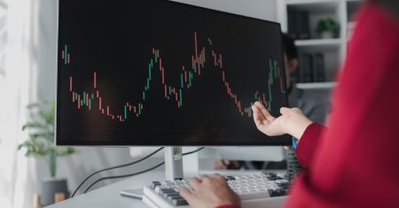 Asian woman looking at stock market graph screen, stock market businessman analyzing stock market rise and fall chart, stock market investor, profit making. investment concept.