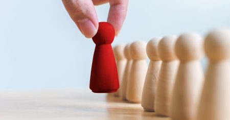 Human resource, Talent management, Recruitment employee, Successful business team leader concept. Hand chooses a wooden people standing out from the crowd.