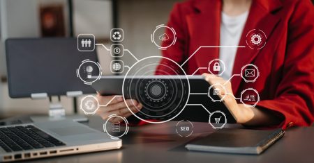 Businesswoman using smartphone and laptop and tablet computer with Digital marketing media in virtual icons interface.